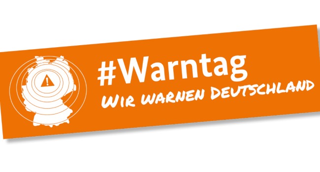 Das Logo des bundesweiten Warntags: Schriftzug Hashtag Warntag. Wir warnen Deutschland. Dazu ein grafisches Symbol: die Fläche er Bundesrepublik, darüber ein Warnzeichen